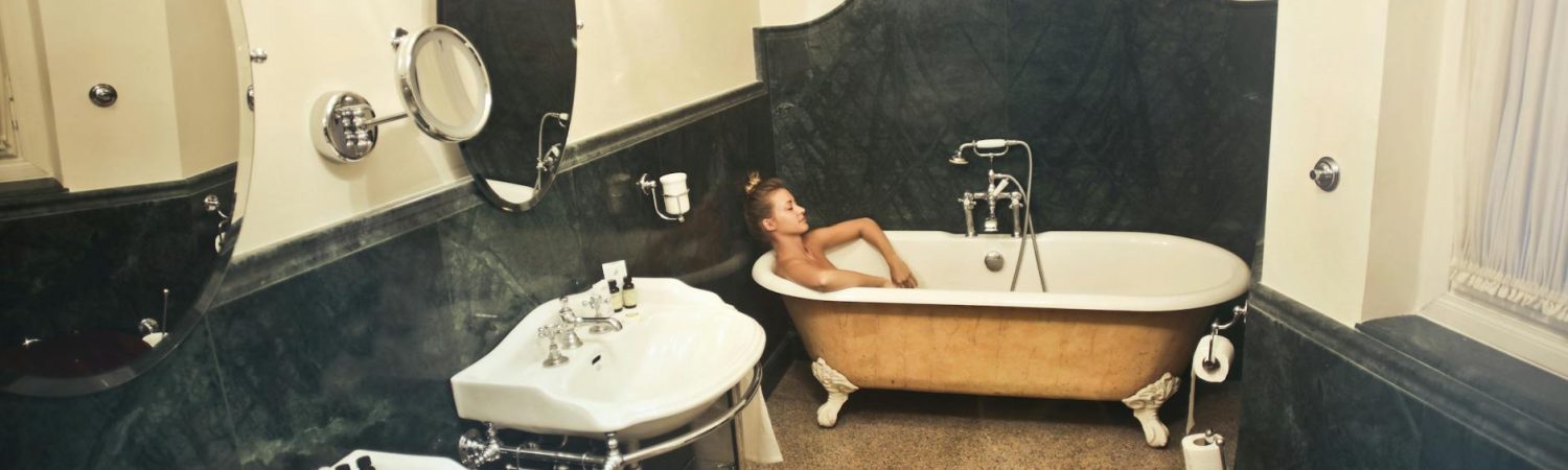 woman relaxing in a bathtub inside a bathroom